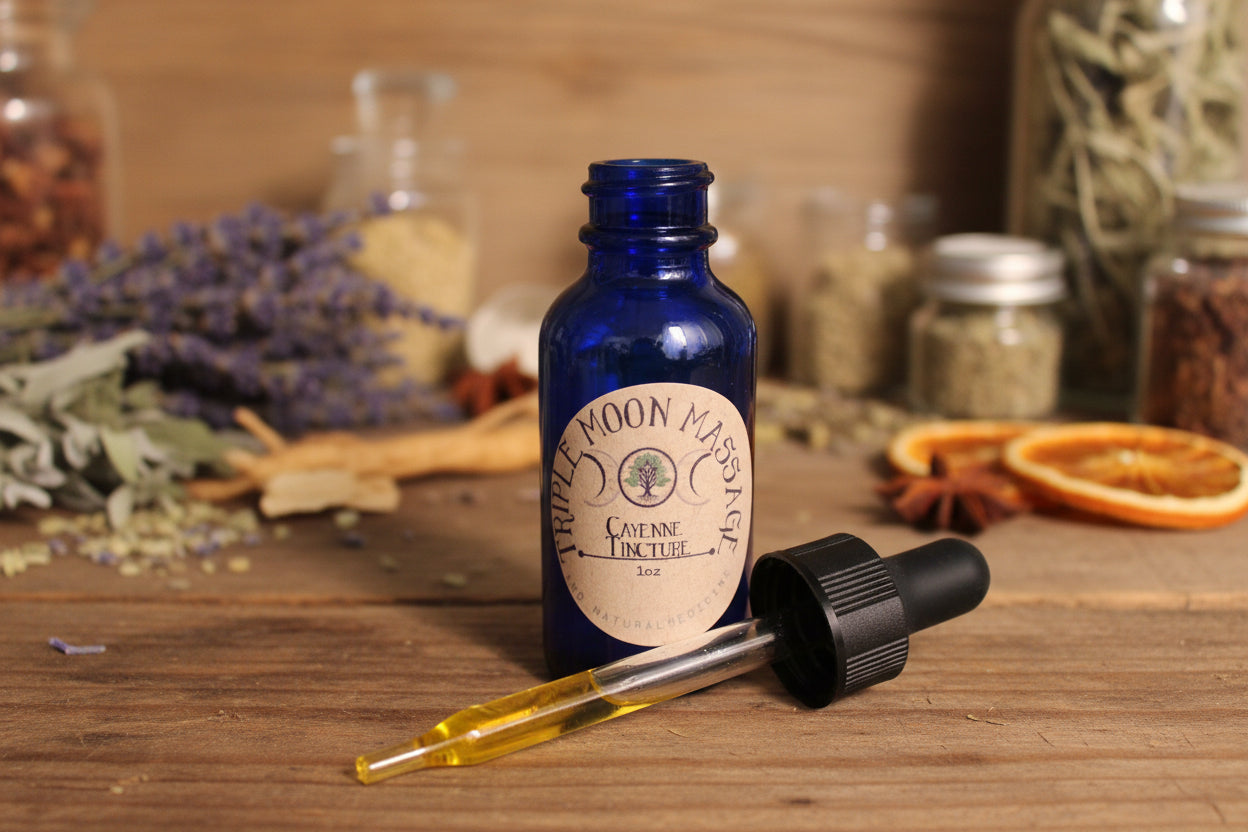 Blue glass bottle with dropper labeled 'Triple Moon Remedies' on a green background